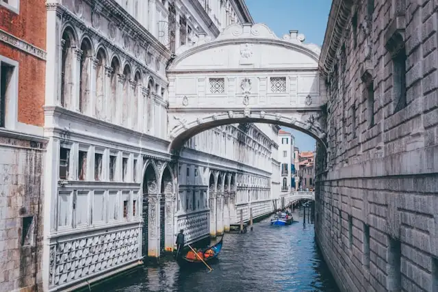 the marble bridge of sighs over a canal in venice italy