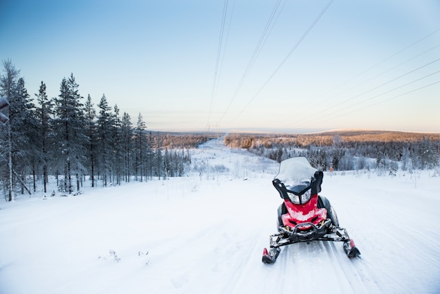 a snowmobile on a snow covered field near rovaniemi in finnish lapland