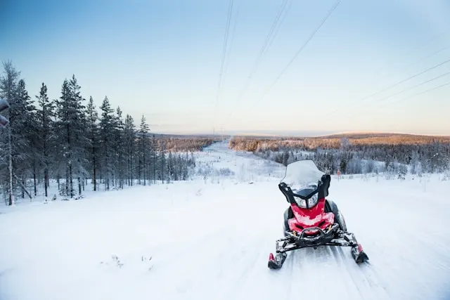 a snowmobile on a snow covered field near rovaniemi in finnish lapland