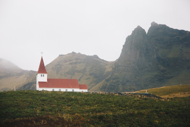 the lutheran church of vik i myral with white walls and a red roof in vik iceland