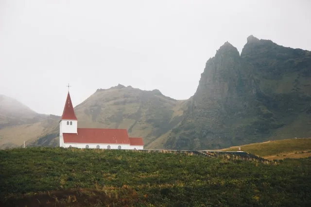 the lutheran church of vik i myral with white walls and a red roof in vik iceland