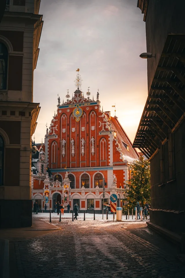 the house of the blackheads in riga latvia is a large red building with a clock on top built in 1334