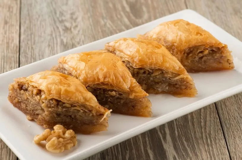 a white rectangular plate containing albanian bakllava