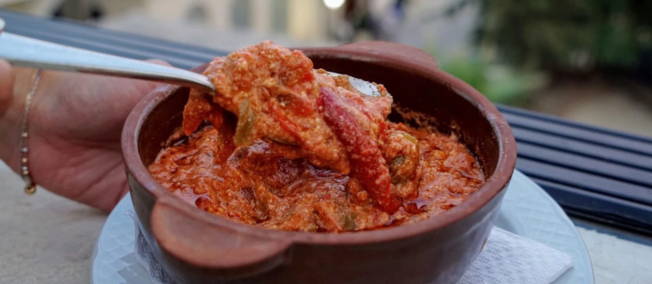 a brown ceramic bowl of fergese a popular albanian traditional food