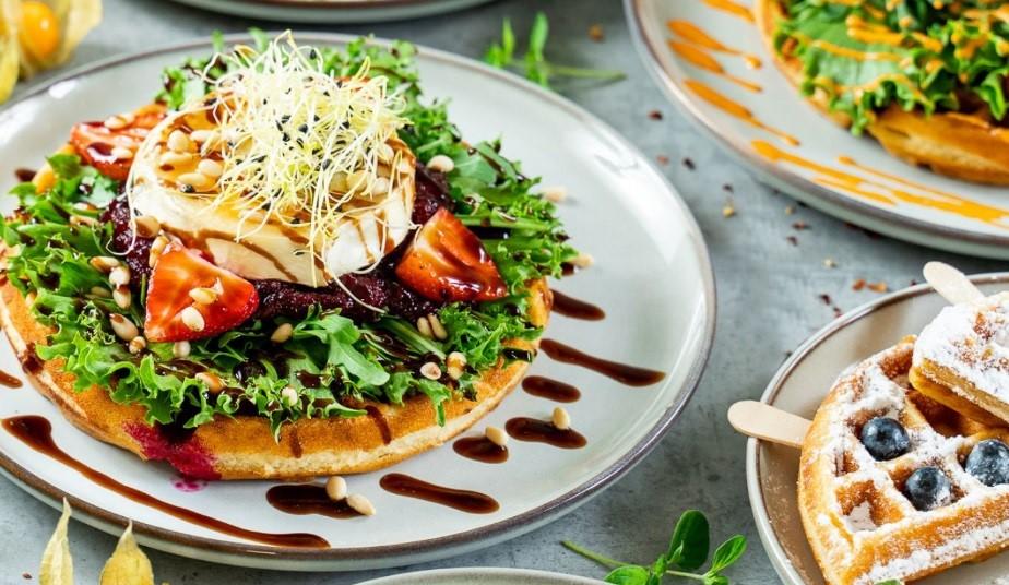 A savory waffle and a sweet waffle presented on a table