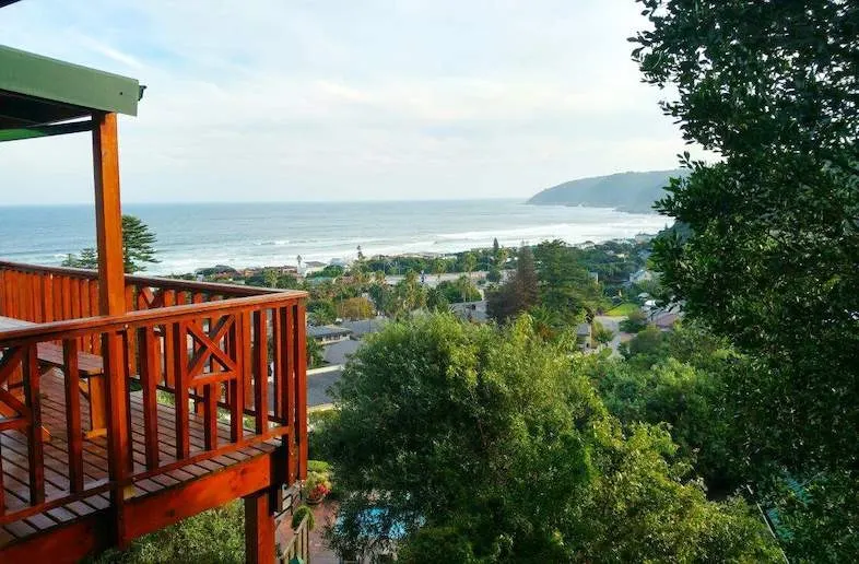 Wilderness village and the ocean beyond it seen from a hillside