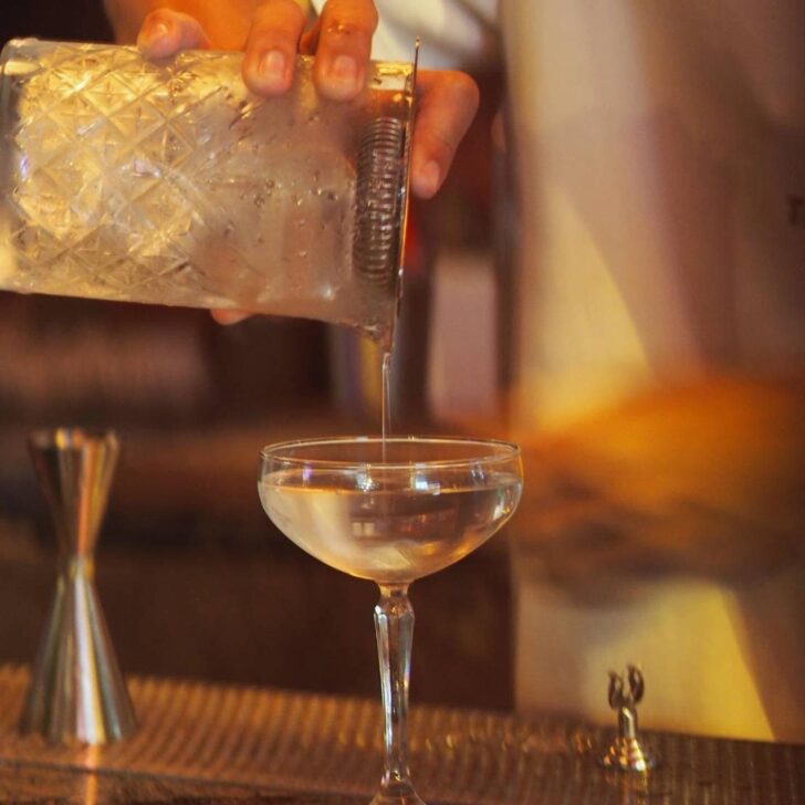 Bartenders pouring a classic martinin