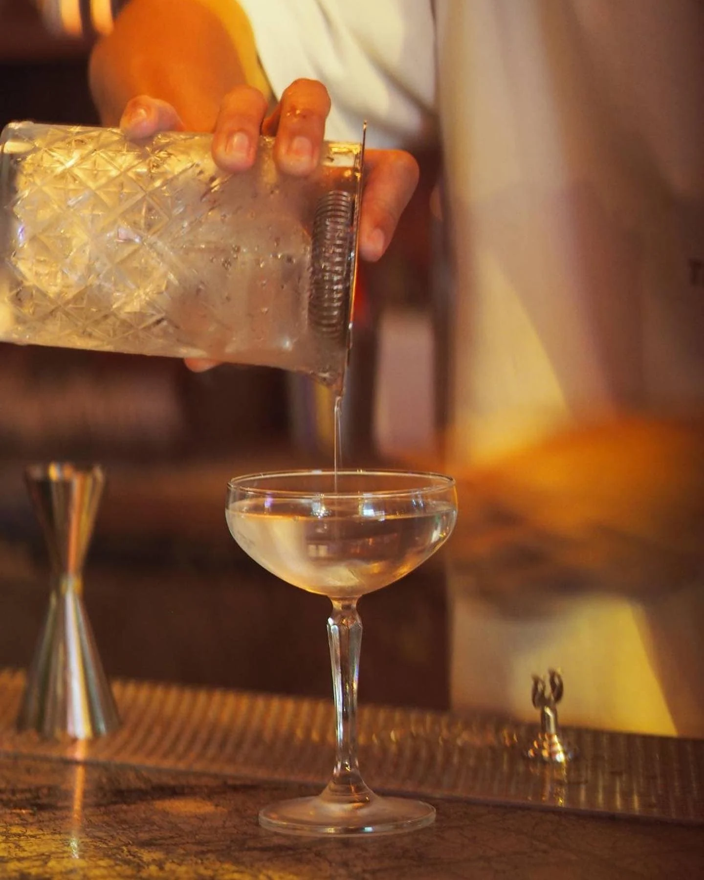 Bartenders pouring a classic martinin