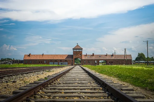 a railway line leading to the entrance of auschwitz nazi concentration camp in poland