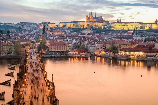 prague castle viewed from the old town side of charles bridge with the vltava river in the foreground