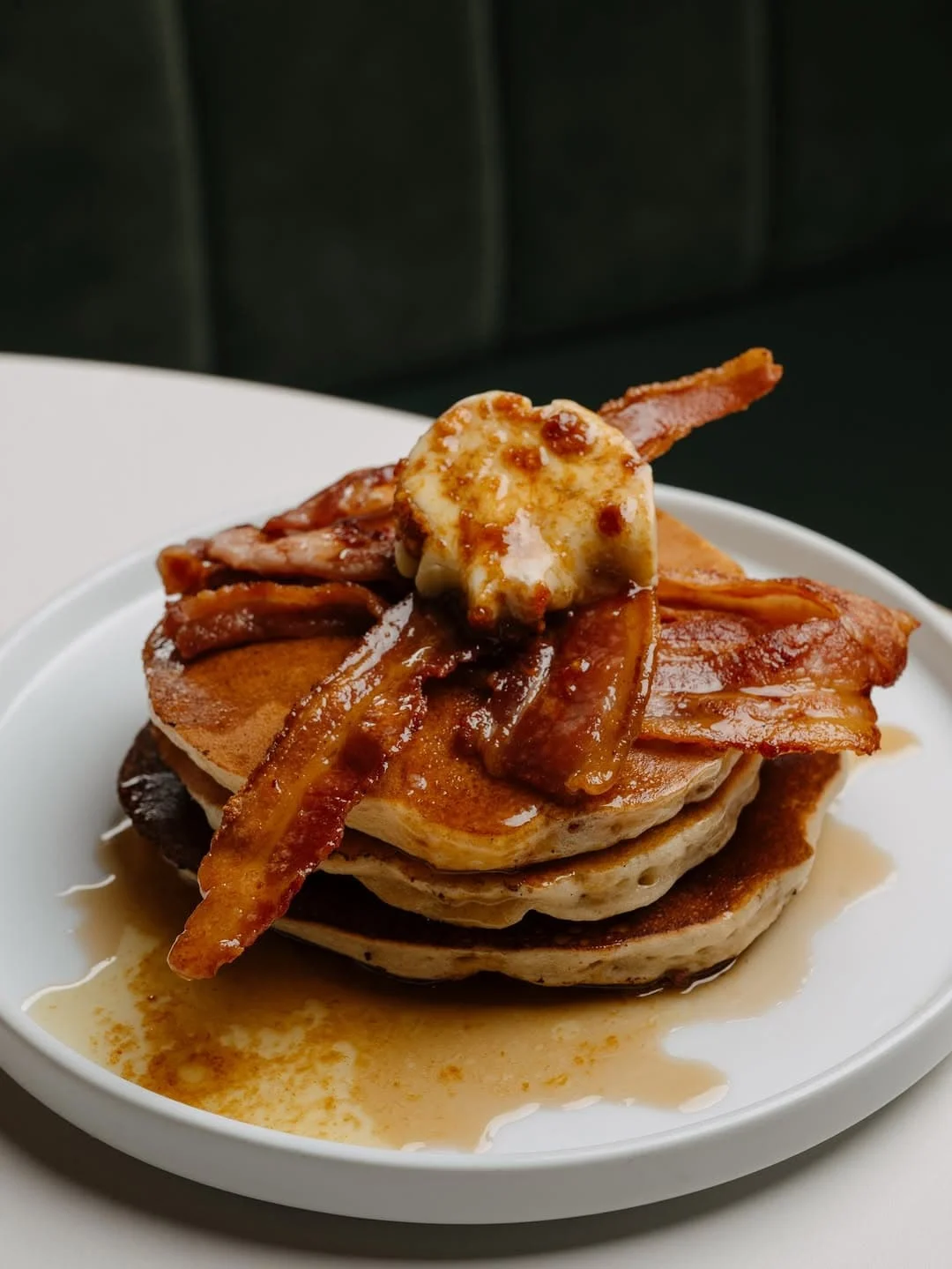 Flapjack / American pancake stack with crispy bacon and maple syrup