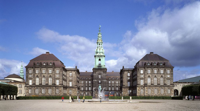 the large christiansborg royal palace with a fountain in front in copenhagen denmark