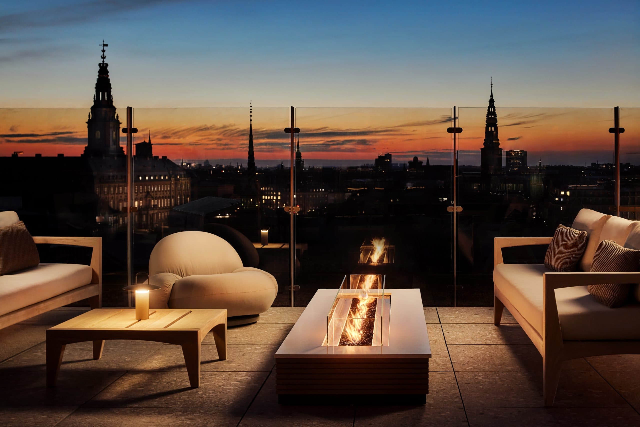 tables around a firepit overlooking copenhagen denmark from roof in christianshavn