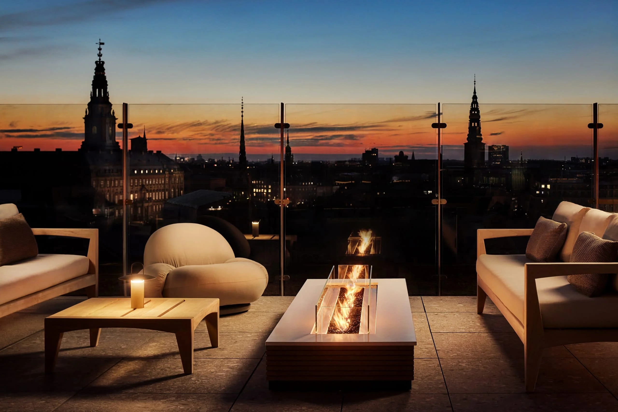 tables around a firepit overlooking copenhagen denmark from roof in christianshavn