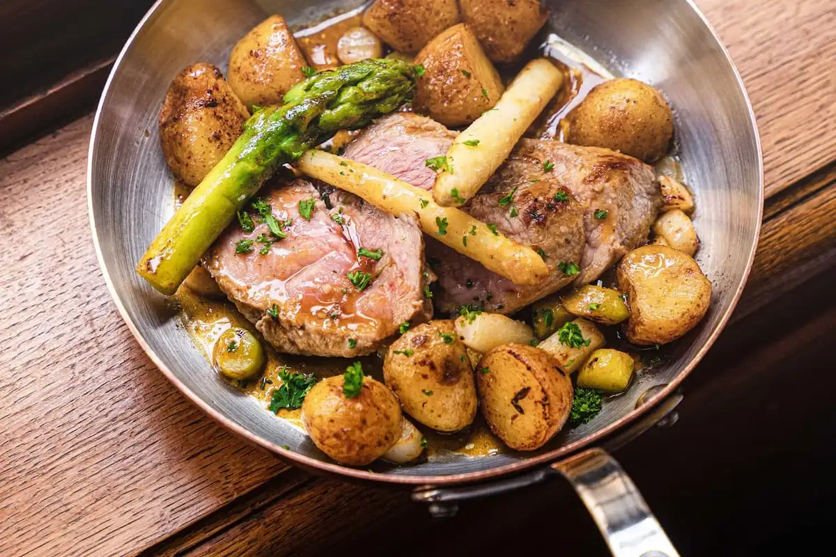 duck with poratoes in a pan at la vieux honfleur restaurant in normandy france