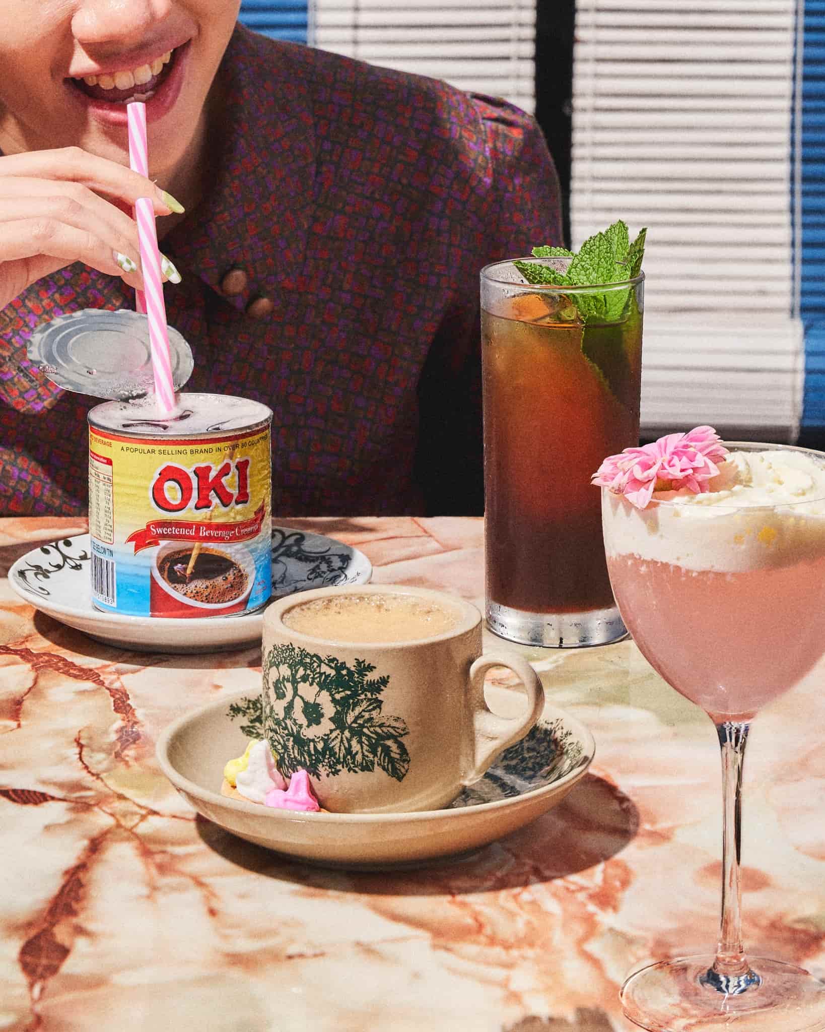Drinks are served in nostalgic tins, cups, and glassware