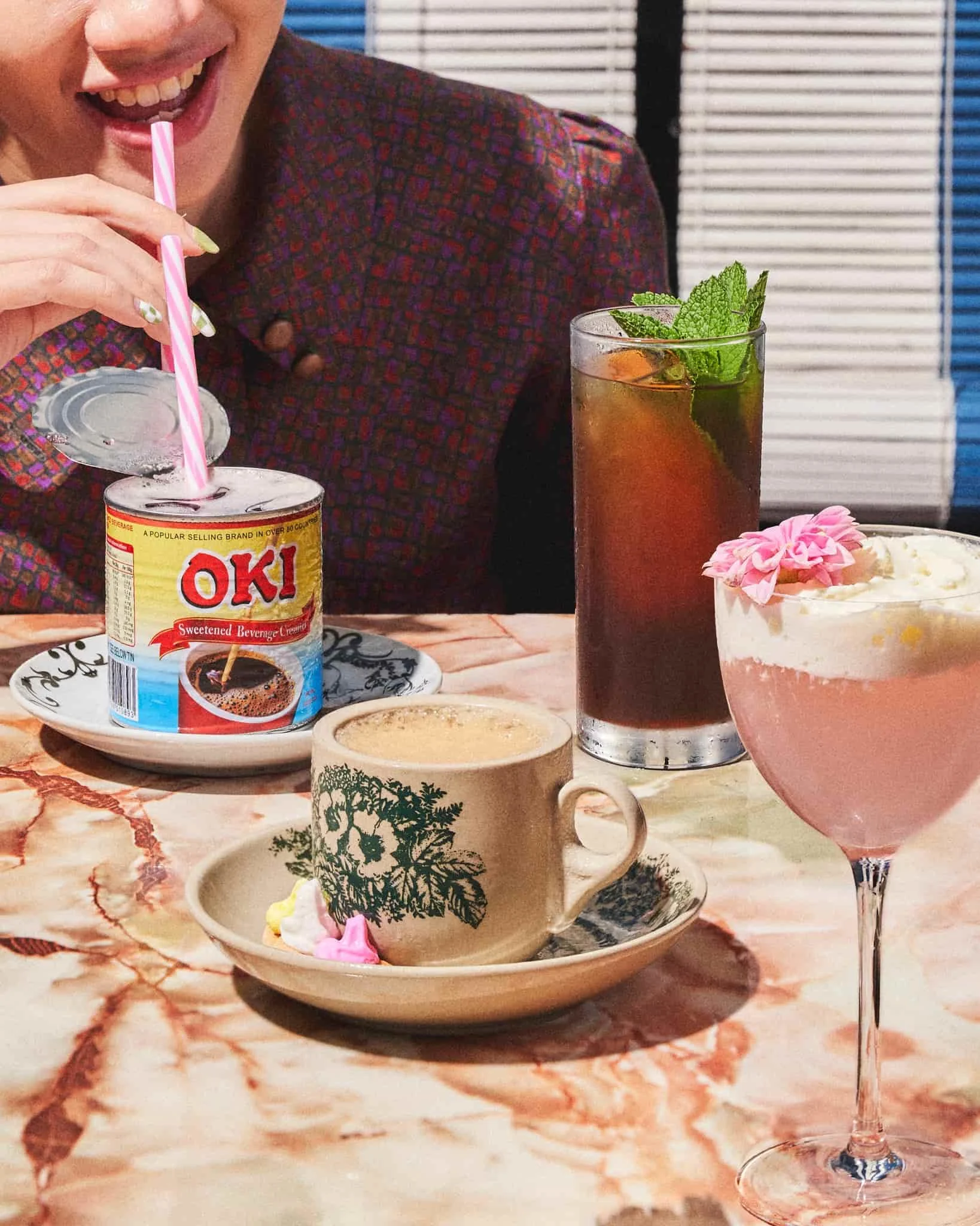 Drinks are served in nostalgic tins, cups, and glassware