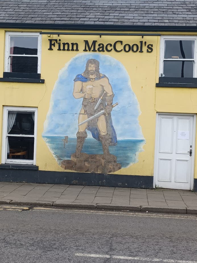 a mural of irish folklore legend finn maccool on the wall of a pub in bushmills northern ireland