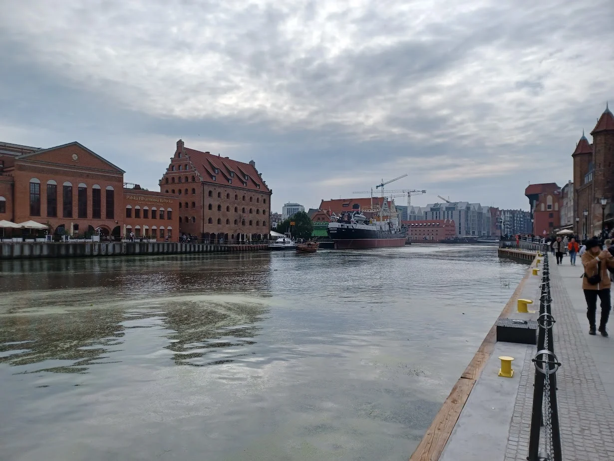the river motlawa flowing past the polish philharmonic in gdansk poland