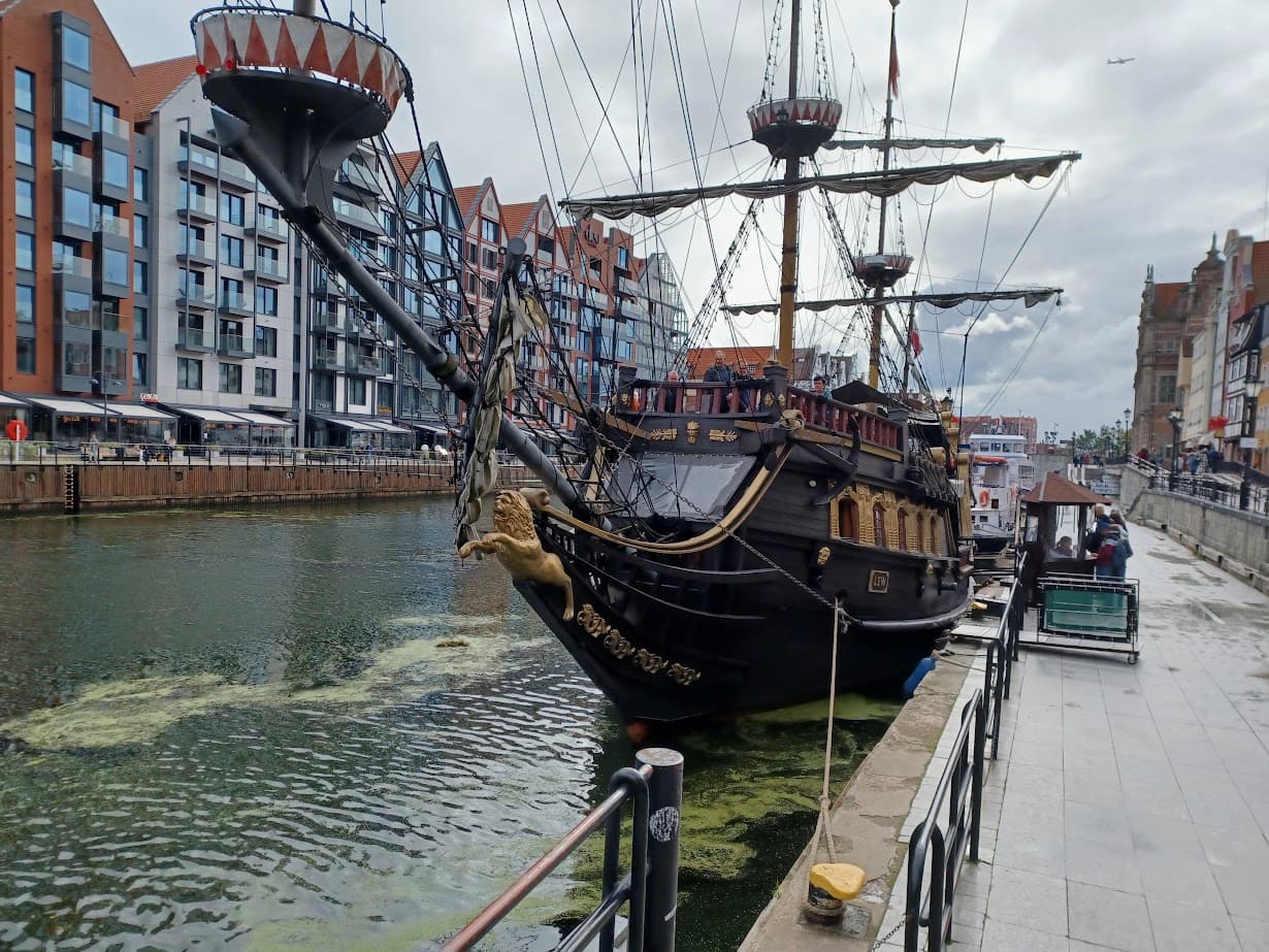 a replica black galleon ship moored on the motlawa river in gdansk poland
