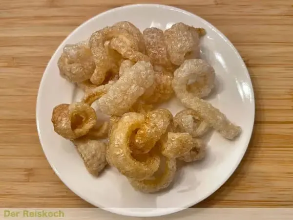 Crispy pork crackling rinds, known as Khaep Mu