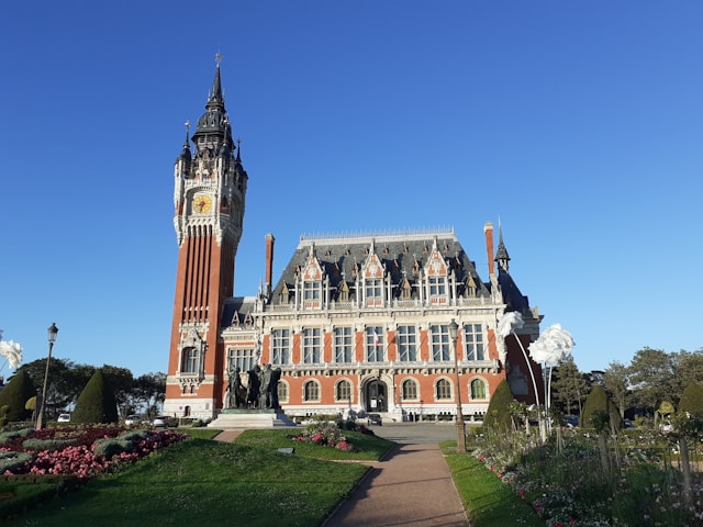 the hotel de ville town hall in calais france with a red brick and white limestone belfry