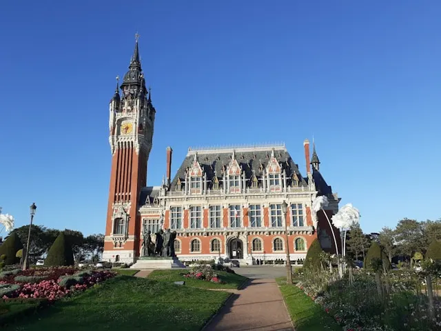 the hotel de ville town hall in calais france with a red brick and white limestone belfry
