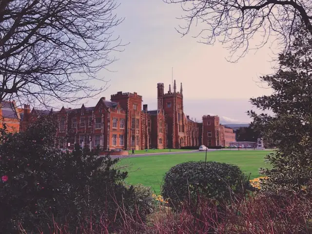 queens university belfast with a grass lawn in the foreground