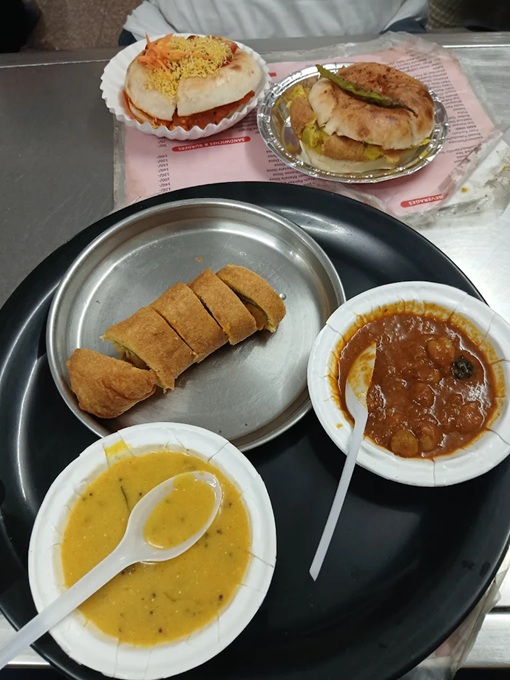 A table laden with assorted snacks in Jaipur, India