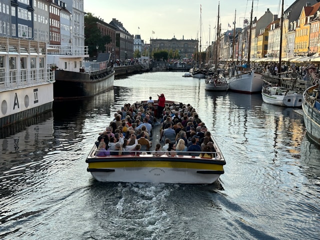 people on an open top canal boat in copenhagen denmark