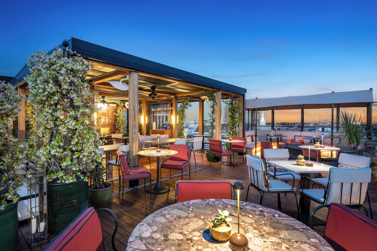 a rooftop terrace with dining tables at bless hotel madrid spain after dark