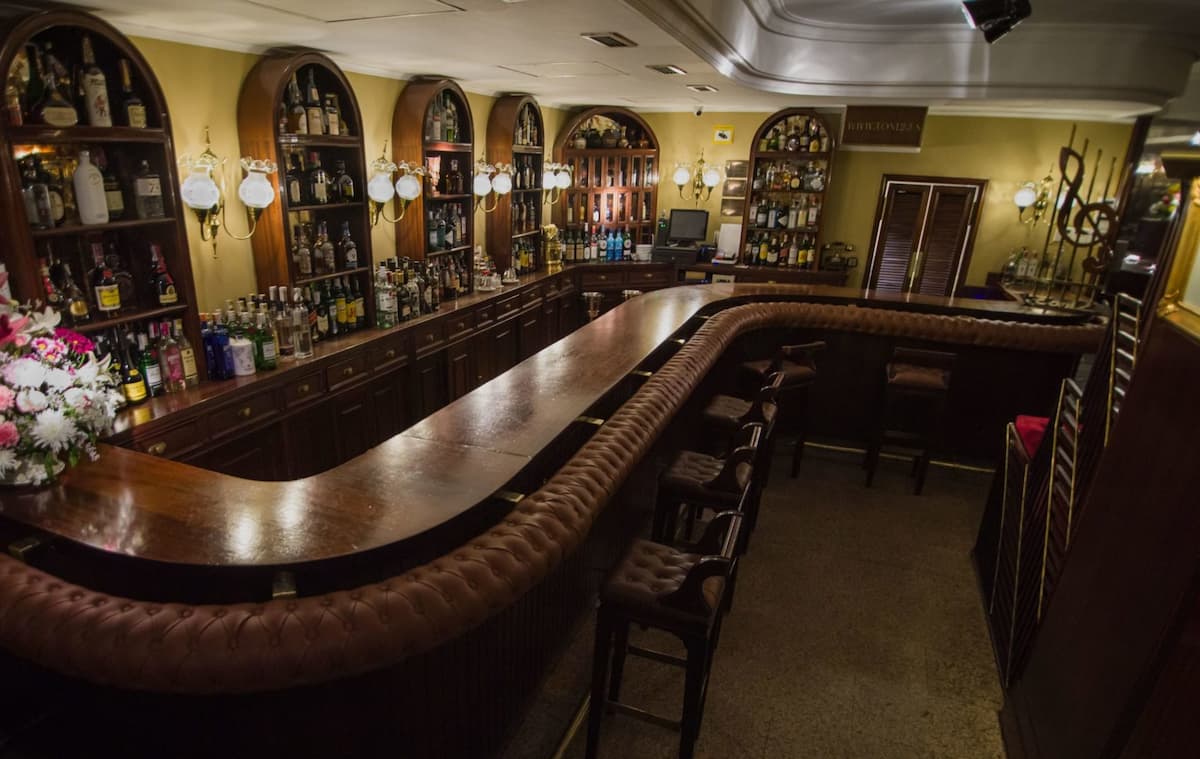 a curved wooden bar at toni 2 piano bar in madrid spain