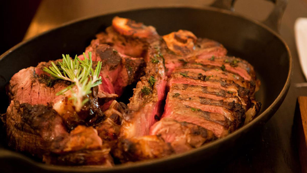 steak served in a black ceramic bowl at MASH Penthouse a steakhouse and cocktail bar in the meatpacking district of copenhagen denmark