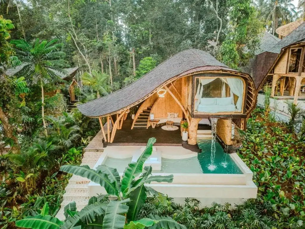 Villa with oblong shaped sloped roof and private pool with water feature