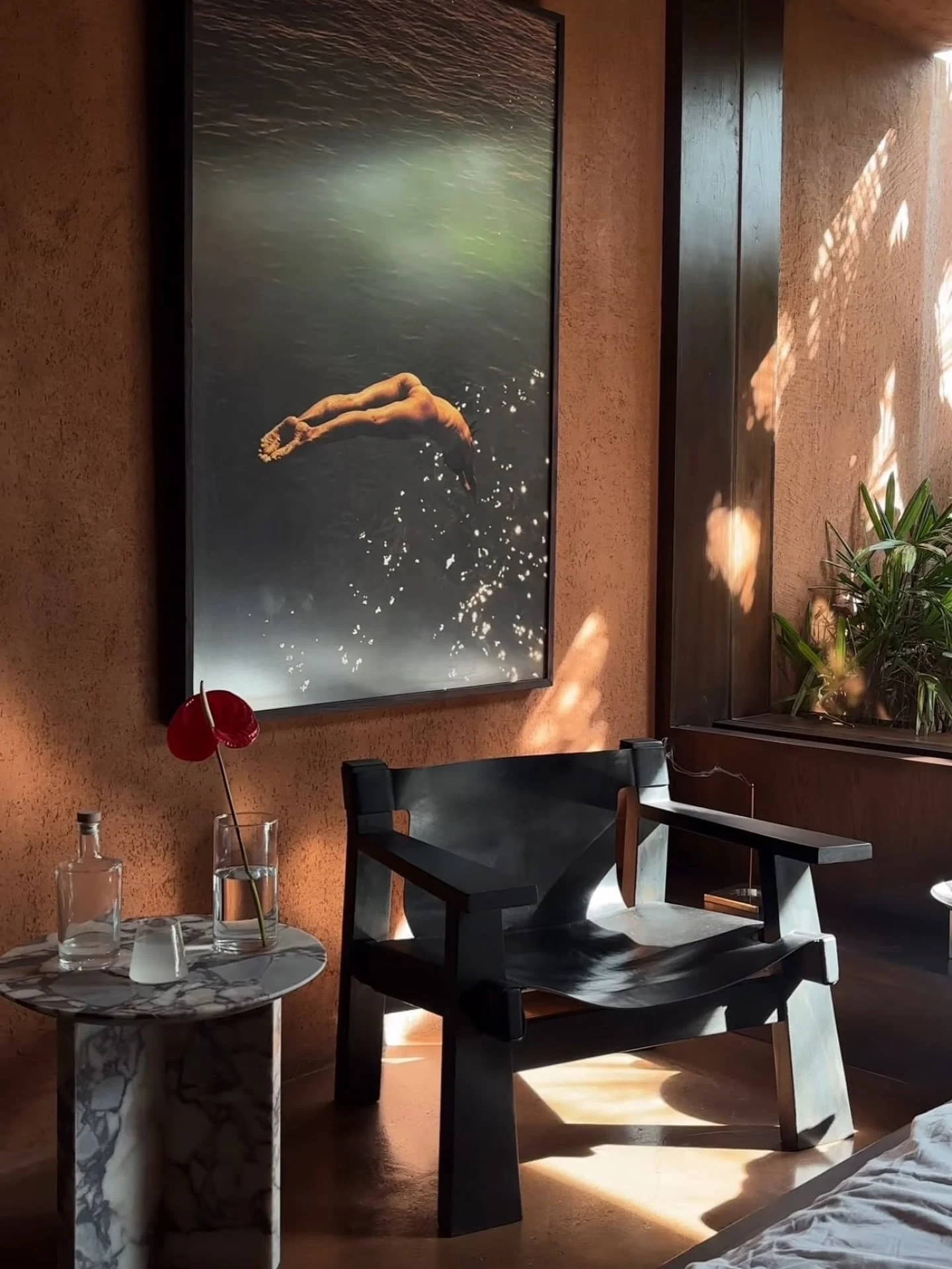 Designer chair and marble side table with artwork