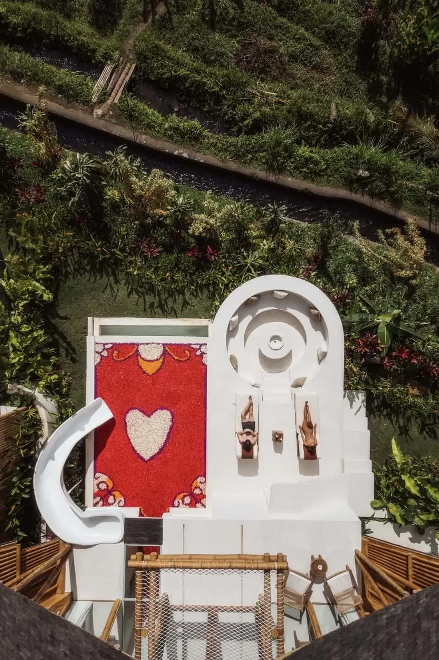 Bird's eye view of private pool villa with slide, sun loungers and private fire pit