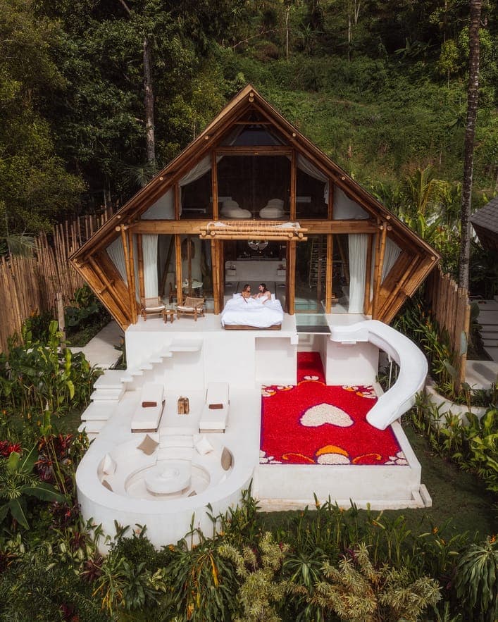 Villa with private slide landing in pool in front, covered with flowers