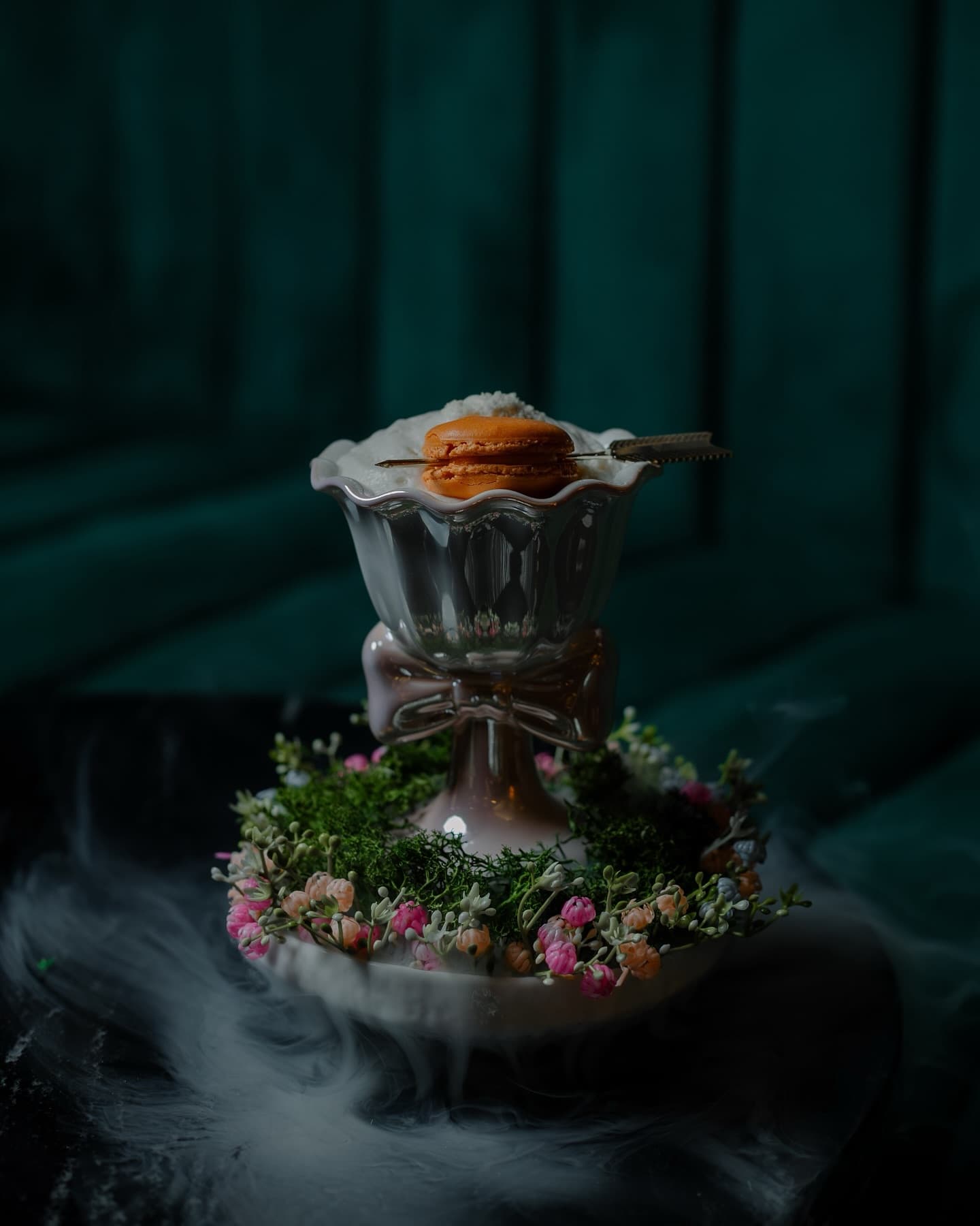 The dessert cocktail disguised by a forest and topped with a macaron