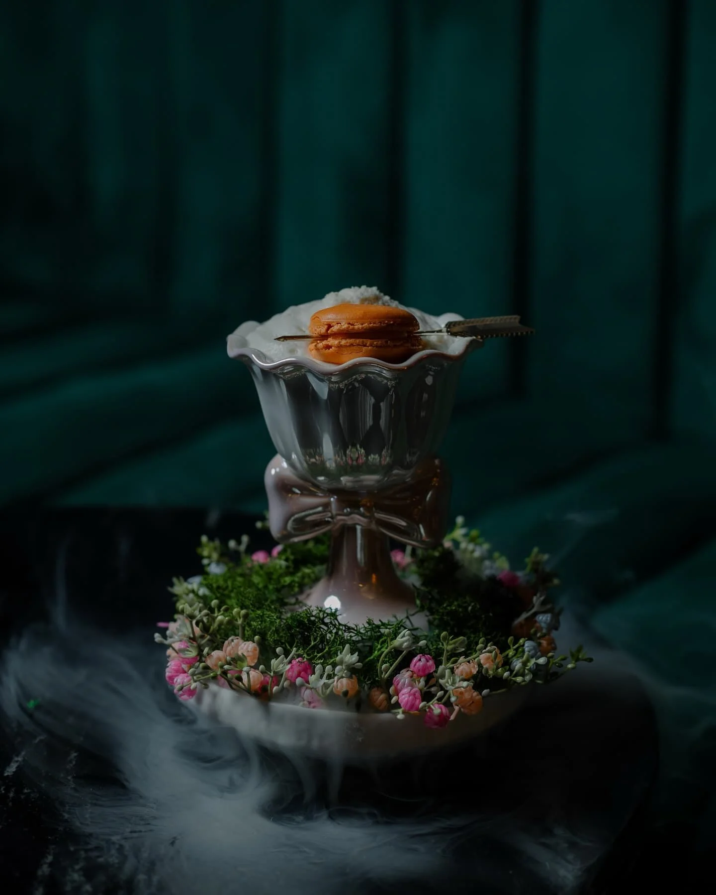 The dessert cocktail disguised by a forest and topped with a macaron