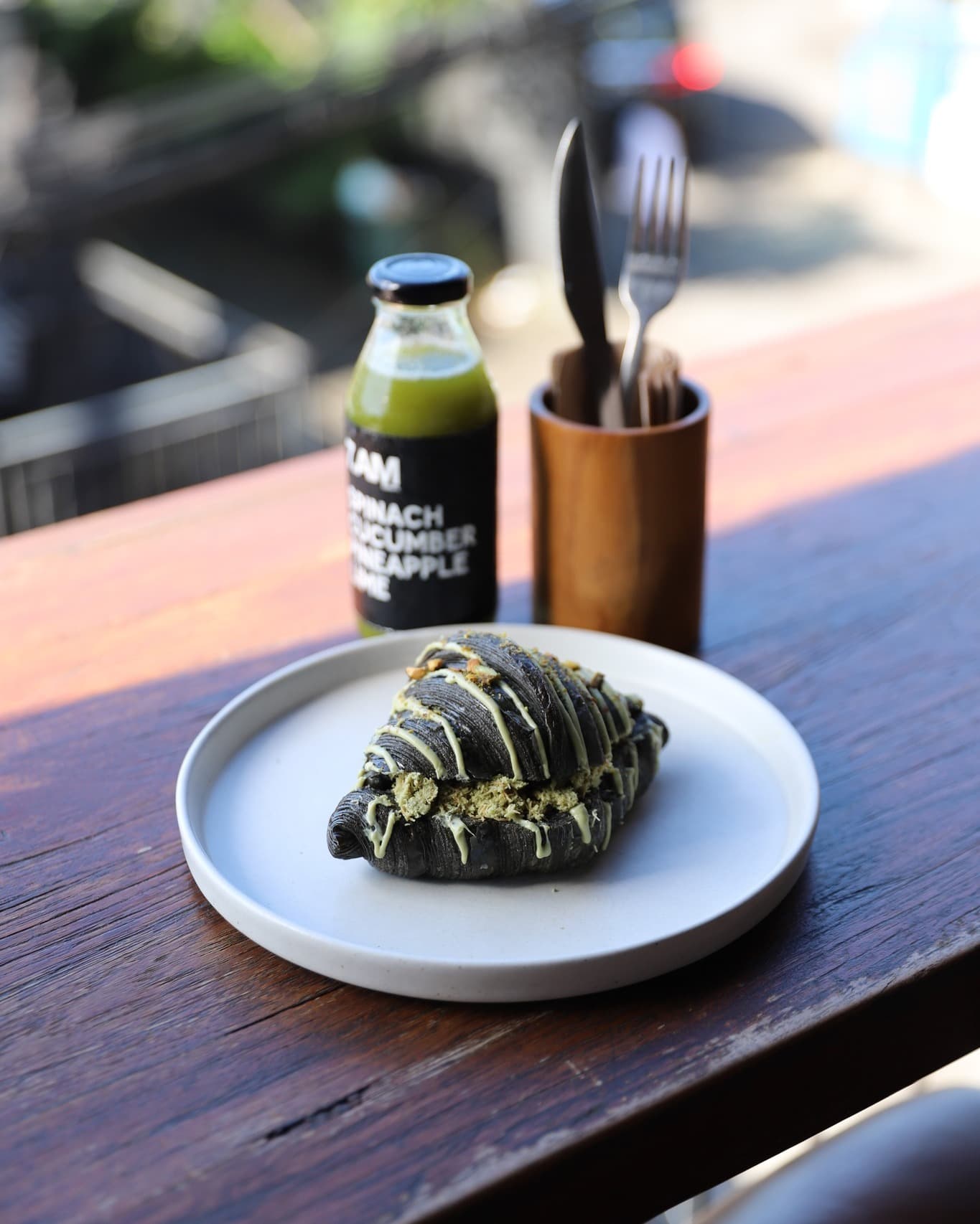 Breakfast black croissant and freshly pressed bottled juice