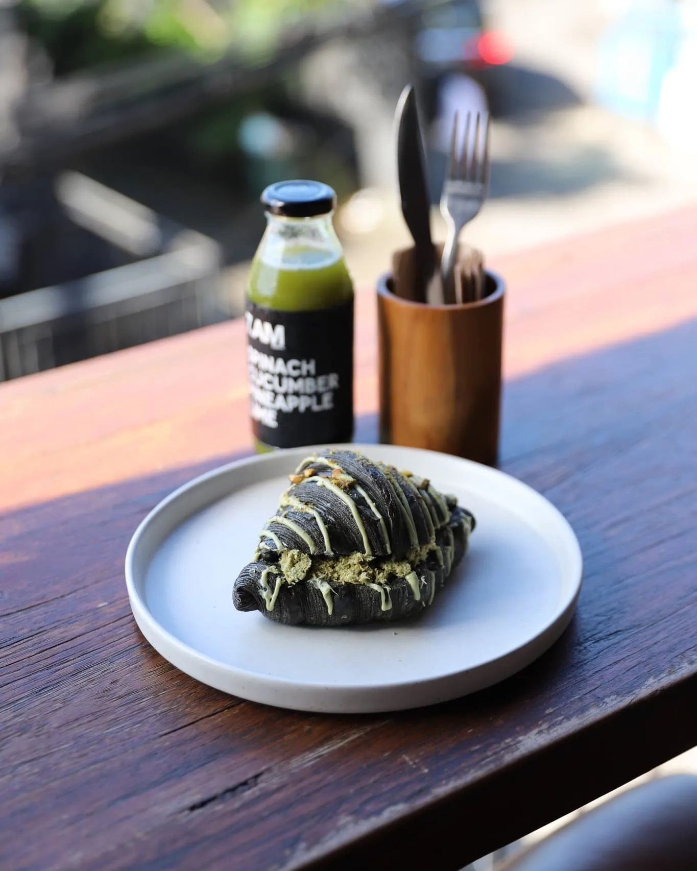 Breakfast black croissant and freshly pressed bottled juice