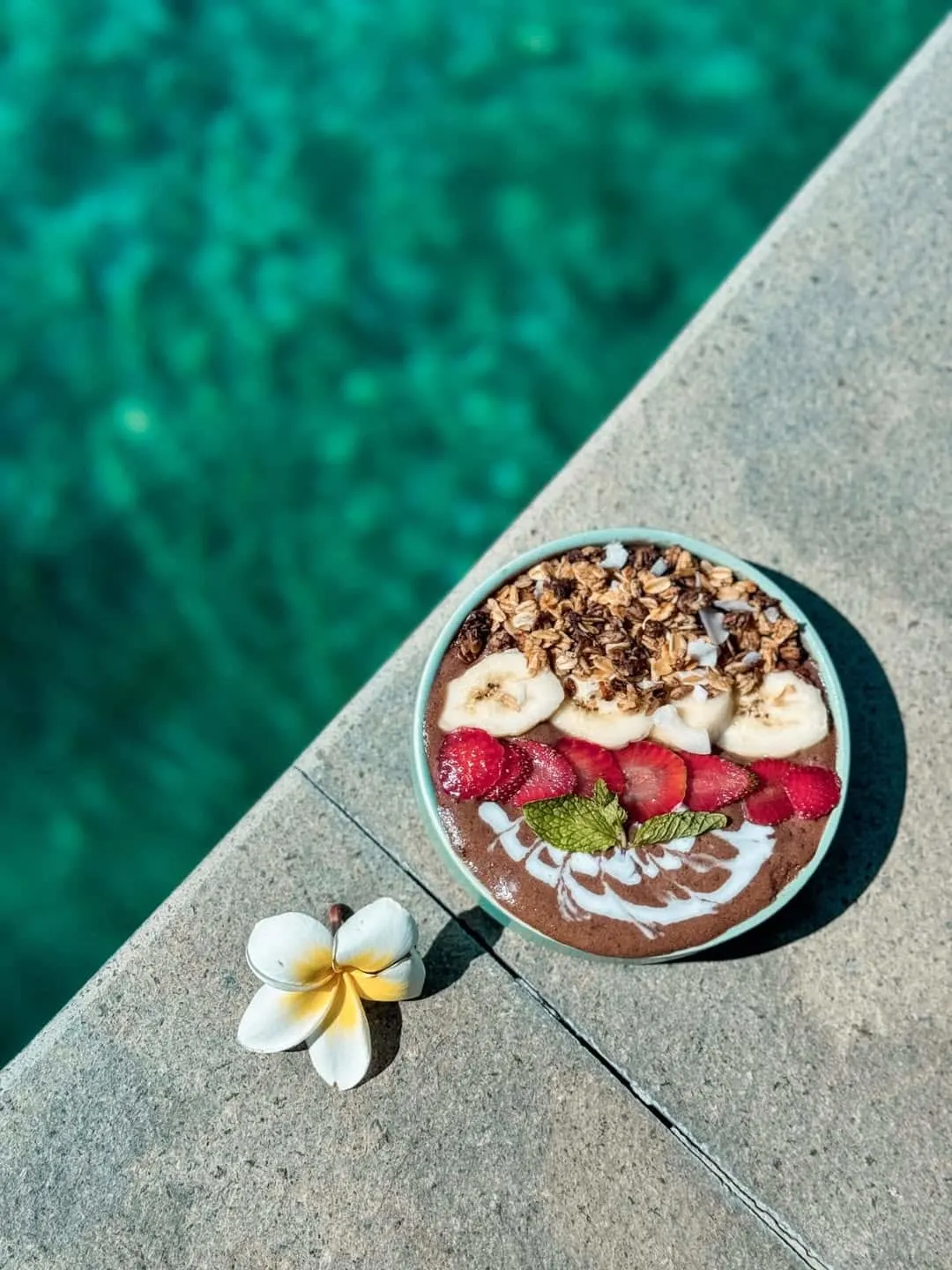 Cacao smoothie bowl next to the cafe's pool