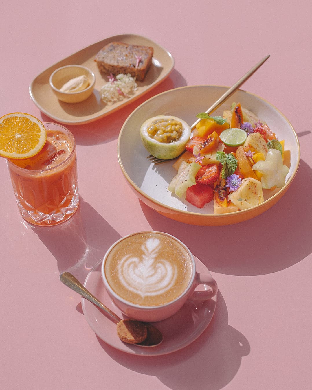 Selection of breakfast dishes, coffee, and fresh juice