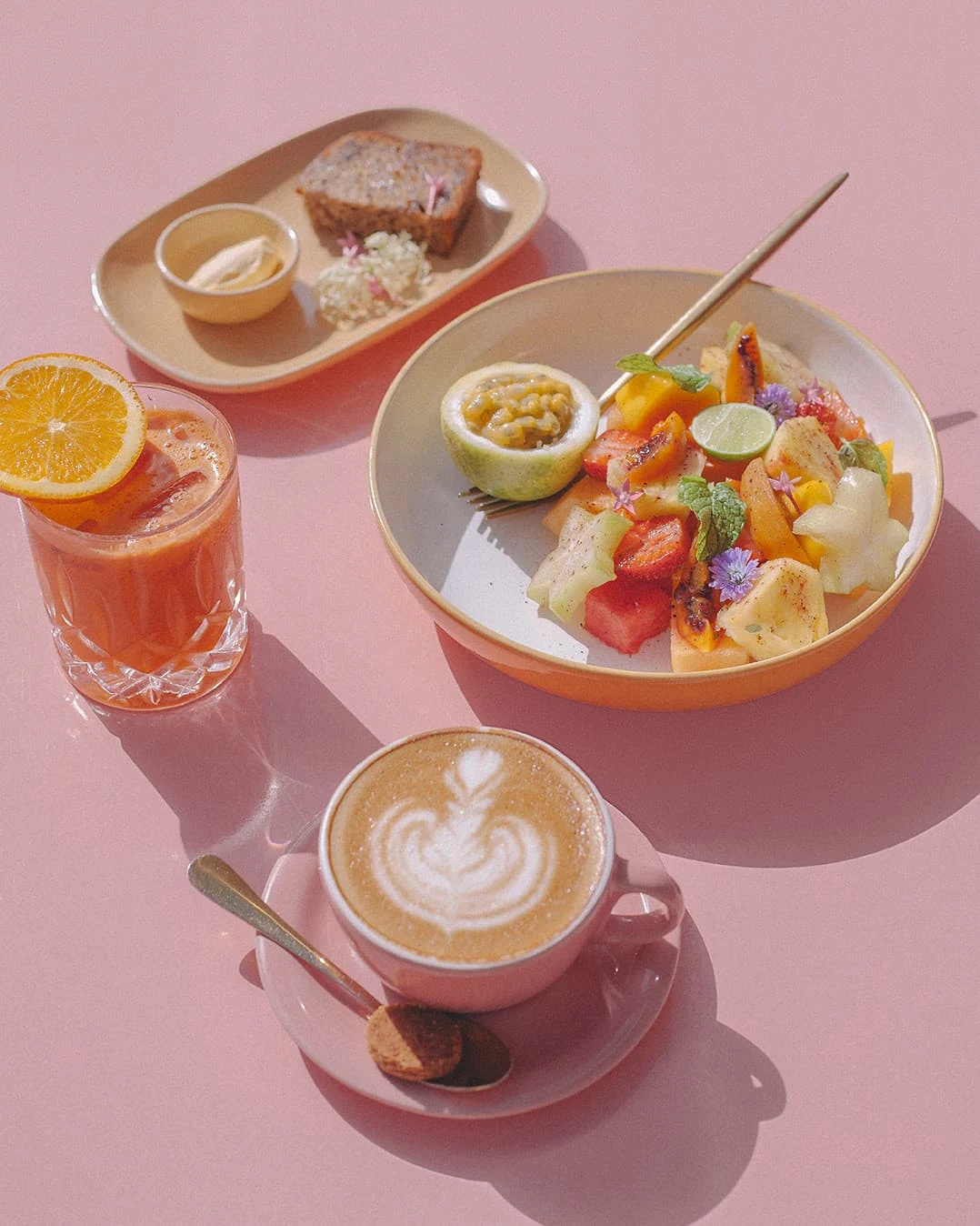 Selection of breakfast dishes, coffee, and fresh juice