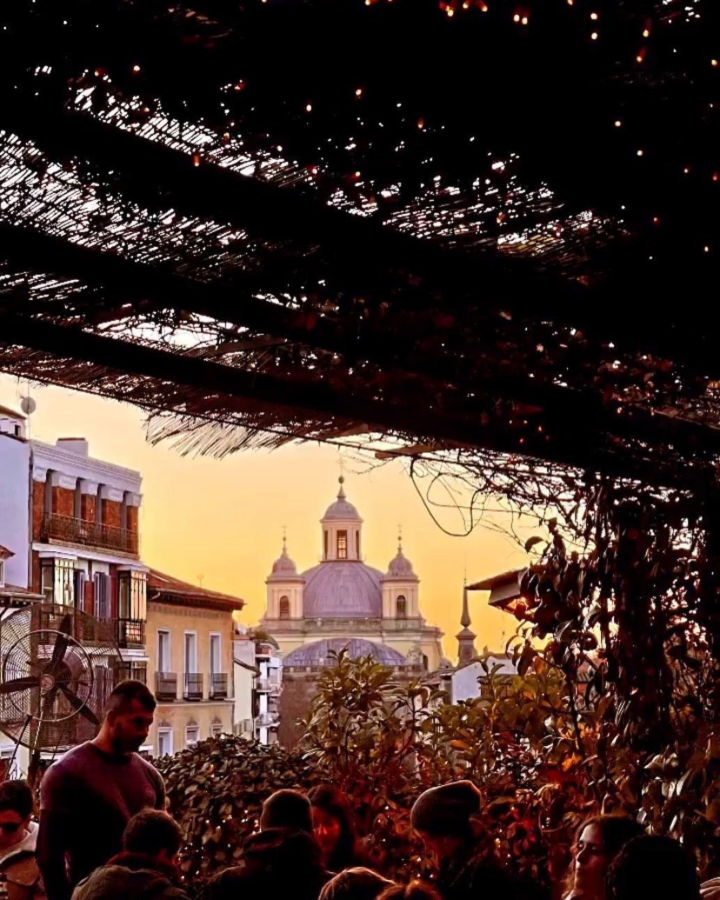 a view of a church from el viajero rooftop tapas bar in madrid spain