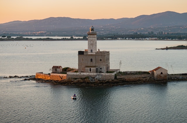 a lighthouse at dusk on faro di bocca islet in the mediterranean sea near olbia sardinia italy