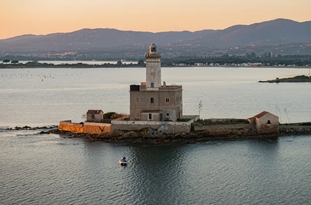 a lighthouse at dusk on faro di bocca islet in the mediterranean sea near olbia sardinia italy