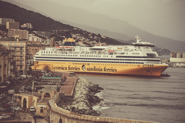 a yellow and white ferry sailing from france to corsica and sardinia