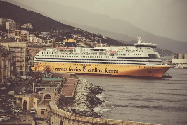 a yellow and white ferry sailing from france to corsica and sardinia