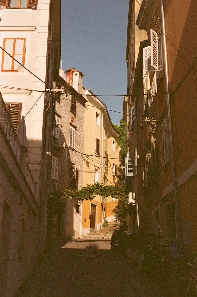 a narrow street with tall houses in villanova cagliari sardinia